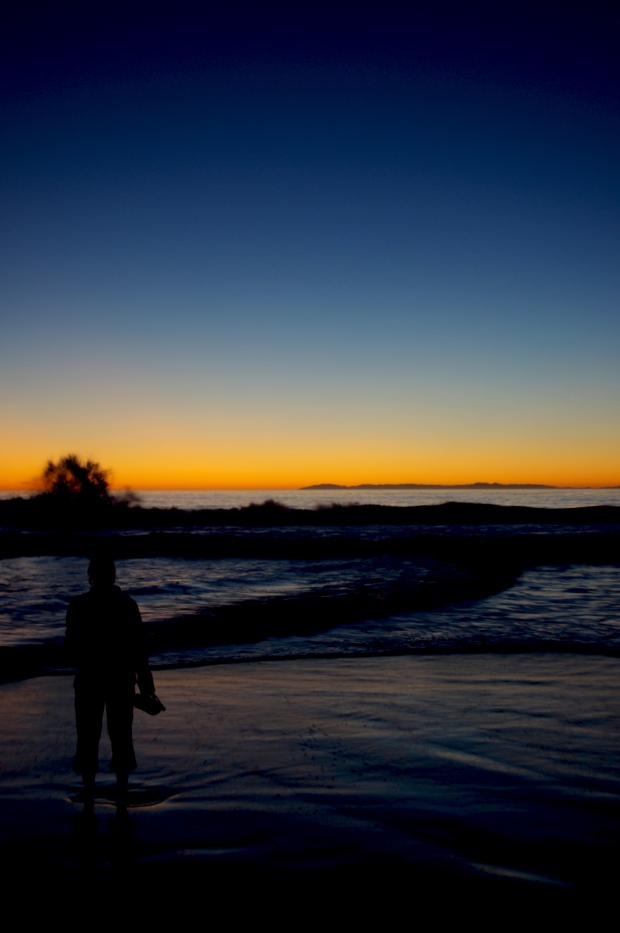 Waves break at sunset in Dana Point, California